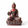 Cherry-colored Medicine Buddha statue in seated pose holding a bowl and healing herb, symbolizing wellness and spiritual healing.